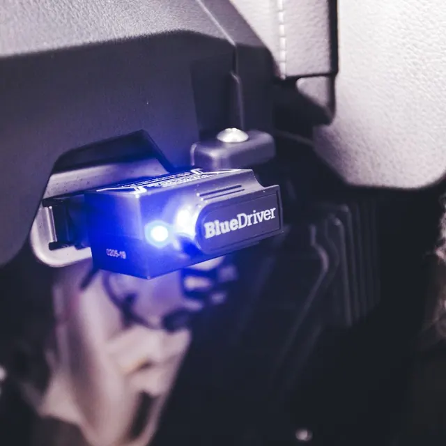 A diagnostic tool plugged into a car
