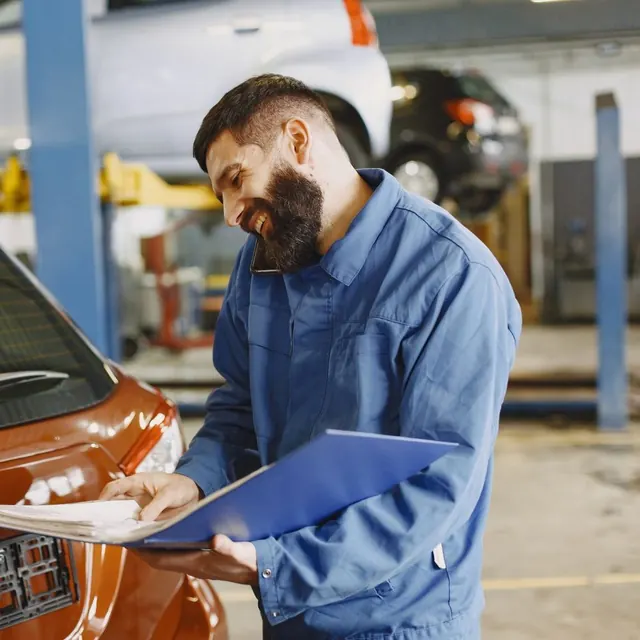 A technician checking a car