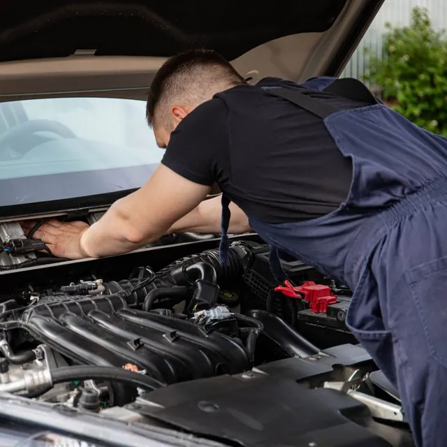 A mechanic working on a car