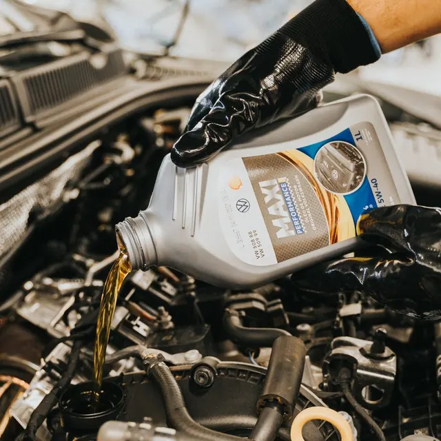 Engine oil being poured during a service